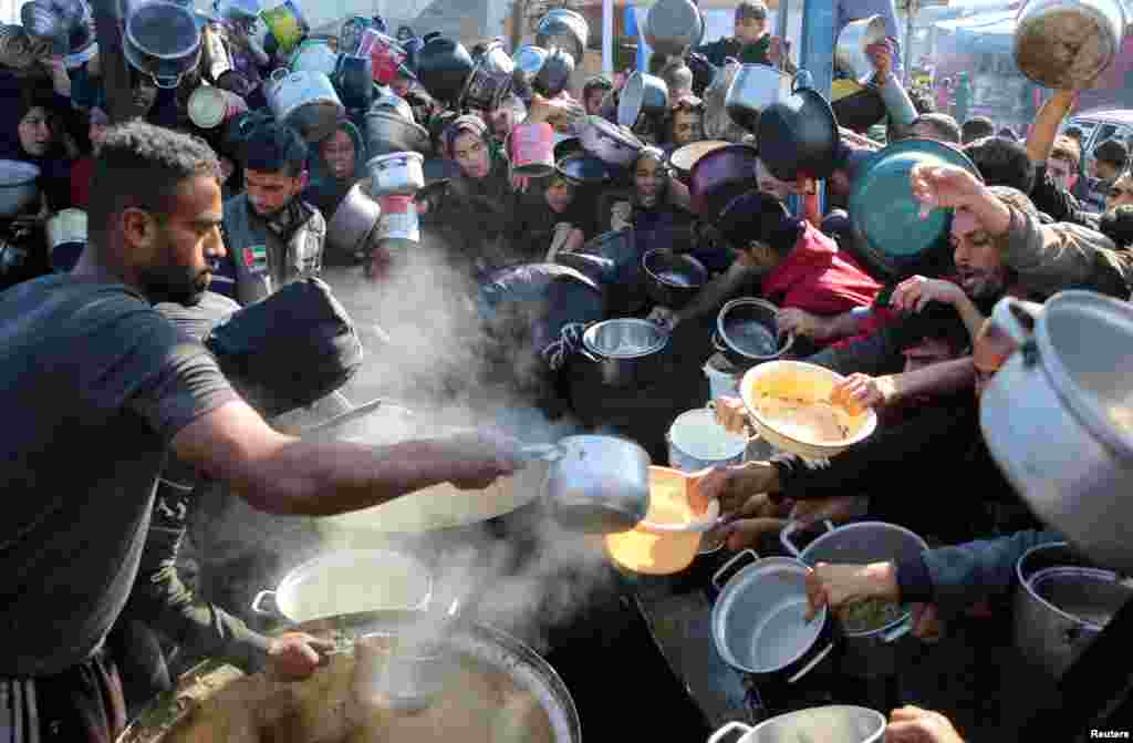 Palestinians gather to receive food cooked by a charity kitchen&nbsp;in Khan Younis in the southern Gaza Strip&nbsp;as the Israel-Hamas conflict continues.