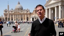 Juan Carlos Cruz, the key whistleblower in Chile's clerical sex abuse scandal, is backdropped by St.Peter's Basilica during an interview with The Associated Press, in Rome, April 24, 2018.