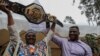 Le Camerounais Francis Ngannou, champion du monde des arts martiaux mixtes poids lourds (à g.), à Bafoussam, au Cameroun, le 1er mai 2021.