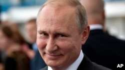 Russian President Vladimir Putin smiles as he visits the Kaliningrad Stadium after the 2018 soccer World Cup in Kaliningrad, Russia, July 20, 2018.