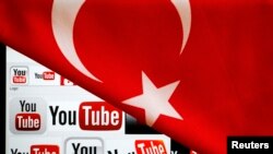 FILE - YouTube logos displayed on a laptop screen partially covered with Turkey's national flag in this photo illustration taken in Ankara, March 27, 2014. 