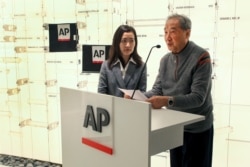 Rao Jian, right, son of Y.C. Jao, speaks during a ceremony at the Associated Press headquarters, in New York, Dec. 11, 2019.