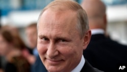 Russian President Vladimir Putin smiles as he visits the Kaliningrad Stadium after the 2018 soccer World Cup in Kaliningrad, Russia, July 20, 2018.