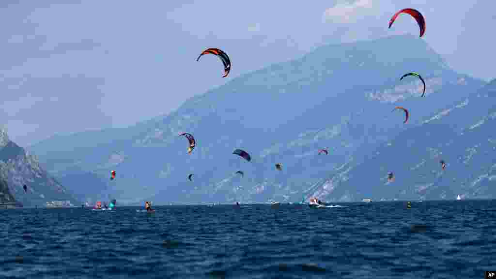 Kitesurfers enjoy the wind at the Garda lake near Brenzone, northern Italy, Aug. 5, 2019.