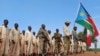 FILE - Military trainees parade during the visit of the defense minister to a military training center in Owiny Ki-Bul, Eastern Equatoria, South Sudan on June 27, 2020. 