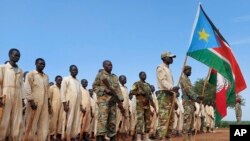 FILE - Military trainees parade during the visit of the defense minister to a military training center in Owiny Ki-Bul, Eastern Equatoria, South Sudan on June 27, 2020. 