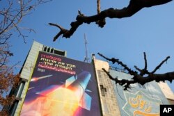 FILE - An anti-Israeli mural showing a launched missile with sign in Farsi reading " Death to America", is seen on a wall at the Felestin (Palestine) Sq. in downtown Tehran, Iran, January 18, 2024.