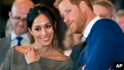 Britain's Prince Harry and Meghan Markle watch a dance performance by Jukebox Collective Cardiff Castle in Cardiff, Wales, Jan. 18, 2018. 