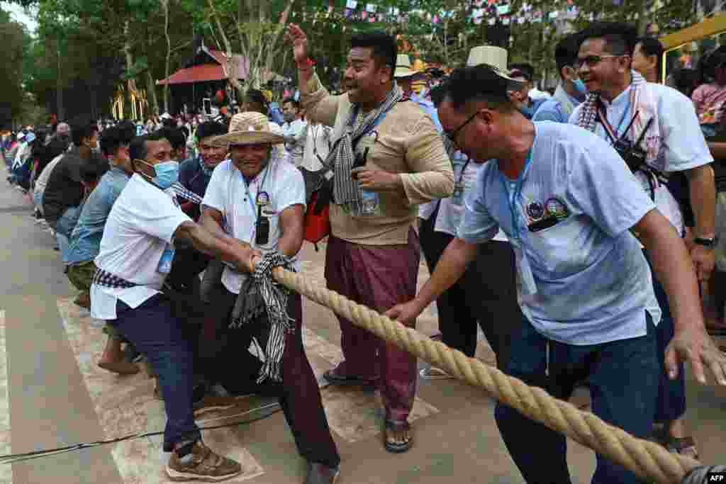 People play a game of tug of war during Khmer New Year celebrations at Chau Say Tevoda temple in Siem Reap province on April 14, 2022.
