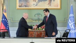 El fiscal de la Corte Penal Internacional, Karim Khan, y el presidente de Venezuela, Nicolás Maduro, se dan la mano durante una reunión en el Palacio de Miraflores, en Caracas, Venezuela, el 3 de noviembre de 2021.