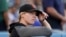 San Francisco Giants coach Alyssa Nakken watches from the dugout during the first inning of the team's baseball game against the Los Angeles Dodgers on Wednesday, July 21, 2021, in Los Angeles.