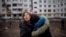A woman reacts as she hugs another woman outside a heavily damaged apartment block in Kharkiv following an artillery attack amid Russia's invasion of Ukraine, April 13, 2022.