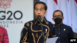 Indonesia's President Joko Widodo gives a speech at the launch of the first public electric vehicle charging station, which will be used for electric vehicles transporting leaders during the G20 conference this year, on Indonesia's resort island of Bali on March 25, 2022.