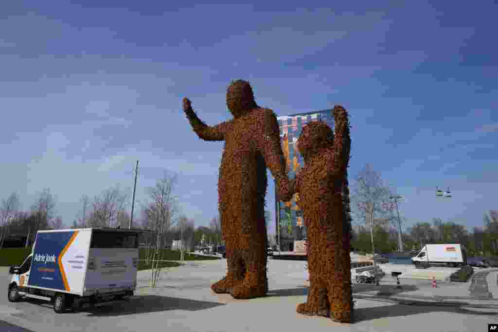 Two giant statues made out of metal bees greet visitors to the once-a-decade Dutch horticultural exhibition called Floriade, in Almere, Netherlands.