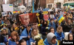 FILE - People gather outside the Consulate General of Ukraine during a Stop Genocide of Ukraine People rally and protest against Russia's invasion of Ukraine, in Times Square in New York City, April 9, 2022.
