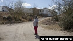 A local woman named Maria shows her property where migrants hide as they await rides in Sunland Park, New Mexico, U.S. on March 23, 2022. (REUTERS/Adria Malcolm)