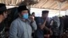 Diplomat Indonesia, Harun Syaifullah Syafa (baju dan masker biru) mengusung jenazah putranya Haekal saat prosesi pemakaman di Boyolali, Kamis (14/4). Haekal menjadi korban kecelakaan di Amerika Serikat. (VOA/ Yudha Satriawan)