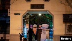 A blocked off gate with a photo of a police officer is seen at an entrance to a residential area under lockdown, amid the COVID-19 pandemic, in Shanghai, China, April 11, 2022.