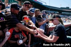 FILE - San Francisco Giants assistant coach Alyssa Nakken signs autographs for fans prior to a spring training baseball game against the Colorado Rockies Thursday, March 31, 2022, in Scottsdale, Arizona. (AP Photo/Ross D. Franklin)