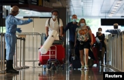 FILE - Passengers from Amsterdam arrive at Changi Airport under Singapore’s expanded Vaccinated Travel Lane (VTL) quarantine-free travel scheme, as the city-state opens its borders to more countries amidst the coronavirus disease (COVID-19) pandemic, in Singapore October 20, 2021.