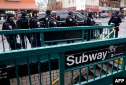 FILE - Members of the New York Police Department patrol the streets after at least 13 people were injured during a rush-hour shooting at a subway station in the New York borough of Brooklyn on April 12, 2022. (Photo by TIMOTHY A. CLARY / AFP)