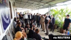 Pol Lt Gen Surachate Hakparn, Assistant to Thai Police Commissioner speaks to Thai victims rescued from scam call centres in Phnom Penh, Cambodia, in this undated handout picture released by Thai police on April 12, 2022. Thai Police/ Handout via REUTERS 