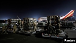 FILE - Ukrainian service members unpack Javelin anti-tank missiles, delivered by plane as part of the U.S. military support package for Ukraine, at the Boryspil International Airport outside Kyiv, Ukraine, Feb. 10, 2022.