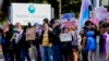 FILE - Transgender rights supporters protest at a hospital in Seattle, Washington, after it postponed some gender-affirming surgeries for minors after an executive order by President Donald Trump, Feb. 9, 2025. A federal judge extended a nationwide block Tuesday on the orders.