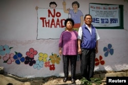 Kim Jeom-sook (left) and Lee Mu-hwan pose for photographs during an anti-THAAD protest, in Seongju, South Korea, June 14, 2017.