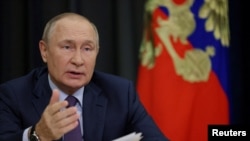 FILE PHOTO: Russian President Vladimir Putin chairs a meeting via video link in Sochi