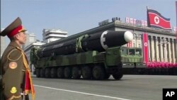 In this image made from video by North Korea's KRT, a military parade is held in Pyongyang, North Korea Thursday, Feb. 8, 2018. North Korea held a massive military parade highlighted by intercontinental ballistic missiles in its capital on Thursday, just one day before South Korea hosts the opening ceremony of the Pyeongchang Winter Olympics. (KRT via AP Video)