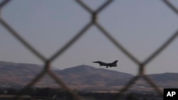 FILE - In this image taken from video, a Greek Air Force F-16 aircraft lands at Cyprus' Andreas Papandreou Air Base near the southwestern coastal city of Paphos, Cyprus, Aug. 25, 2020. 