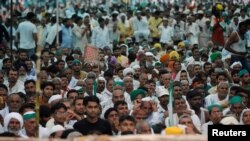 People attend a Maha Panchayat or grand village council meeting as part of a farmers' protest against farm laws in Muzaffarnagar in the northern state of Uttar Pradesh, India, Sept. 5, 2021.