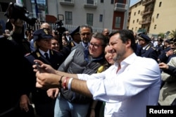 FILE - Italian Interior Minister Matteo Salvini takes a selfie with supporters in Corleone, Sicily, Italy April 25, 2019.