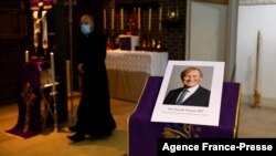 A photograph of Conservative British lawmaker David Amess, who was fatally stabbed, is pictured prior to a service at Saint Peter's Catholic Parish of Eastwood in Leigh-on-Sea in southeast England on Oct. 15, 2021