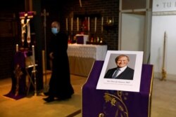 A photograph of Conservative British lawmaker David Amess, who was fatally stabbed, is seen prior to a service at Saint Peter's Catholic Parish of Eastwood in Leigh-on-Sea, Essex, England, Oct. 15, 2021.