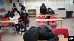 A student rests on his desk as the Mojave Unified School District in California. (AP Photo/Damian Dovarganes)
