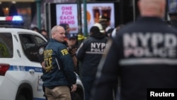 Law enforcement officers work near the scene of a shooting at a subway station in the Brooklyn borough of New York City, New York, U.S., April 12, 2022.