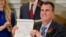 Oklahoma Gov. Kevin Stitt shows his signature on a bill that makes it a felony to perform an abortion, punishable by up to 10 years in prison, in Oklahoma City, Apr. 12, 2022.