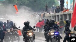 Police disperse protesters during a rally in Jakarta, Indonesia. Thousands of students marched in cities around the country to protest against rumors that the government is considering postponing the 2024 presidential election to allow President Joko Widodo to remain in office beyond the two-term legal limit, calling it a threat to the country's democracy.