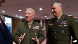 FILE - Gen. Stephen Townsend, commander of the U.S. Africa Command, right, with Gen. Kenneth McKenzie, commander of the U.S. Central Command, arrive at a Senate Armed Services Committee hearing on the readiness of the military in Africa and the Middle East on March 15, 2022.