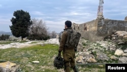 An Israeli soldier looks out towards Lebanon, after a ceasefire between Israel and Hezbollah took effect, near Israel's border with Lebanon, in northern Israel Jan. 26, 2025.