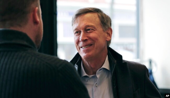 Former Democratic Colorado Governor John Hickenlooper talks with AmeriCorps members prior to a roundtable campaign stop in Manchester, N.H., March 22, 2019.