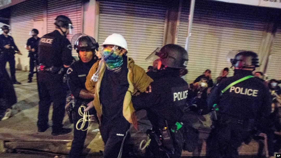 FILE - In this May 31, 2020, photo, Los Angeles police officers arrest a demonstrator where Police Department is investigating 56 allegations of misconduct during protests against police brutality in the wake of George Floyd's death. 