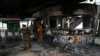 A police officer walks in a subway station that was torched during protests, in Santiago, Chile, Oct. 19, 2019. The protests began Friday afternoon when high school students flooded subway stations, dodging fares and vandalizing stations over a fare hike.