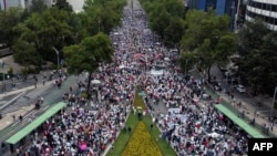 This aerial view shows hundreds of students and judiciary workers marching in front of the Senate of the Republic to protest against the judicial reform proposed by the Mexican government in Mexico City, Sept. 8, 2024. 