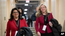 FILE - Rep.-elect Rashida Tlaib, D-Mich., left, and Rep.-elect Abigail Spanberger, D-Va., head to a Democratic Caucus meeting in the basement of the Capitol.