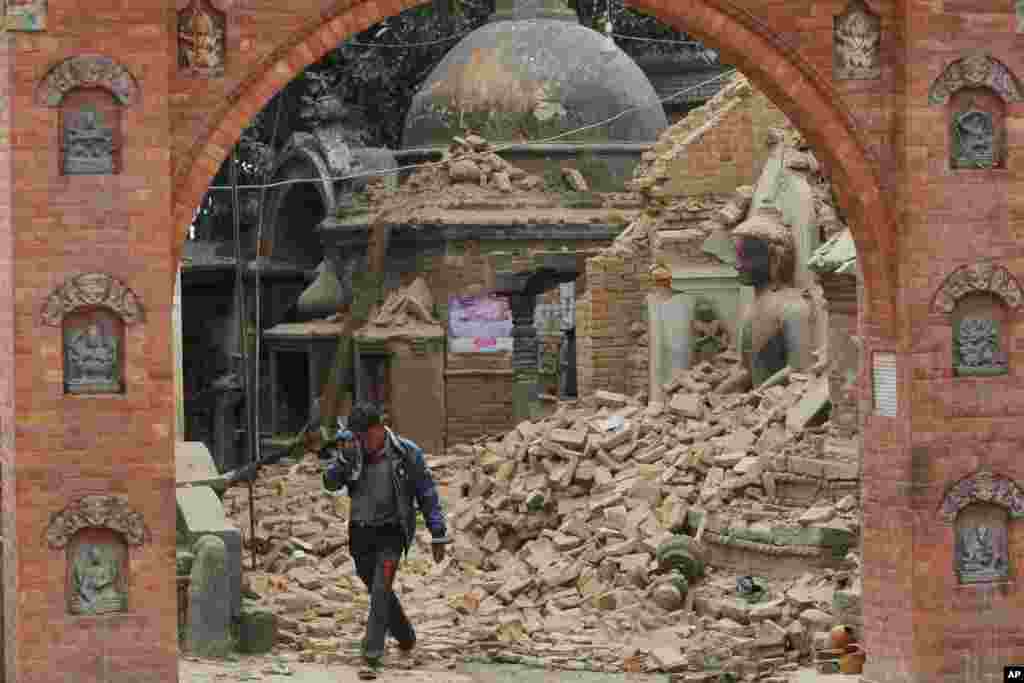 A Nepalese man cries as he walks through the earthquake debris in Bhaktapur, near Kathmandu, Nepal.