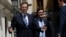 Spain's Prime Minister Mariano Rajoy (L) reacts to a question from a reporter as he leaves after a session at the Senate in Madrid, Aug. 1, 2013.
