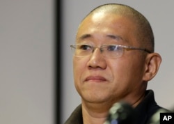FILE - Kenneth Bae talks to reporters at Joint Base Lewis-McChord, Washington, Nov. 8, 2014.